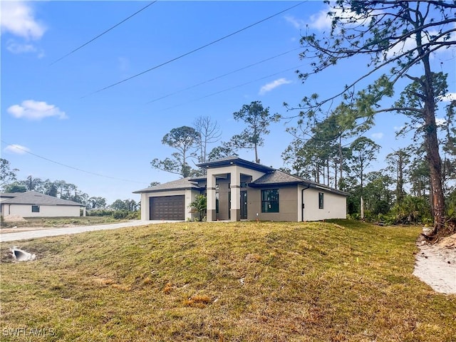 view of front of property featuring a garage and a front yard