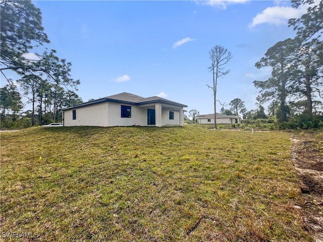 view of side of property with a lawn