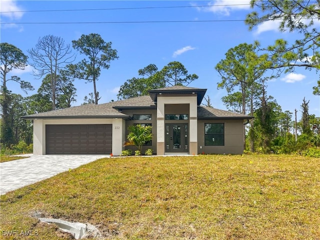 view of front of house with a garage and a front lawn