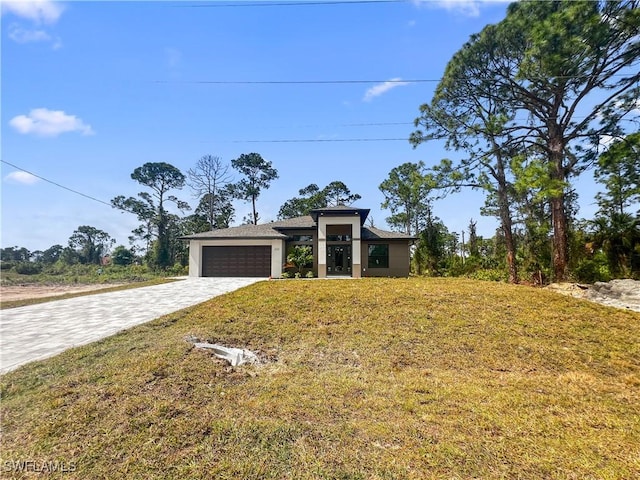 view of front of property featuring a garage and a front lawn