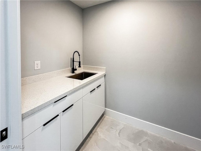 clothes washing area with sink