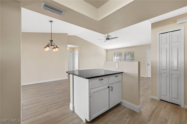 kitchen featuring decorative light fixtures, light hardwood / wood-style floors, white cabinetry, and ceiling fan with notable chandelier