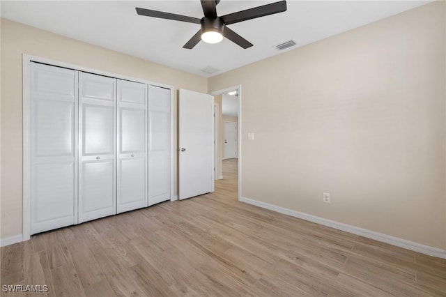 unfurnished bedroom featuring ceiling fan, a closet, and light hardwood / wood-style floors