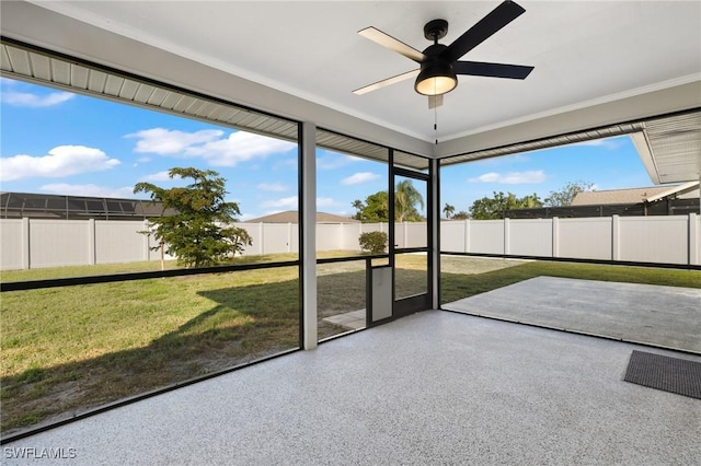 unfurnished sunroom with ceiling fan