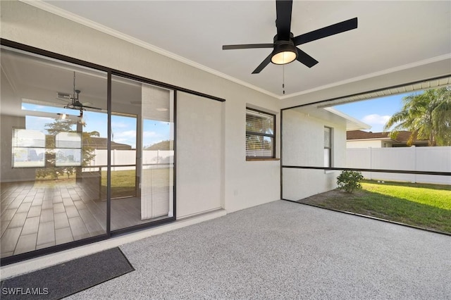 unfurnished sunroom with ceiling fan