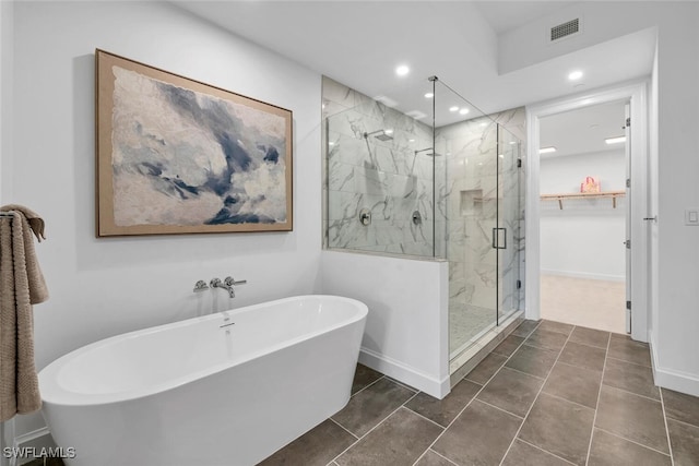 full bath featuring recessed lighting, a freestanding tub, visible vents, and a marble finish shower