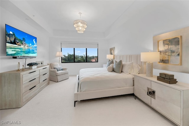 bedroom featuring light carpet and a notable chandelier