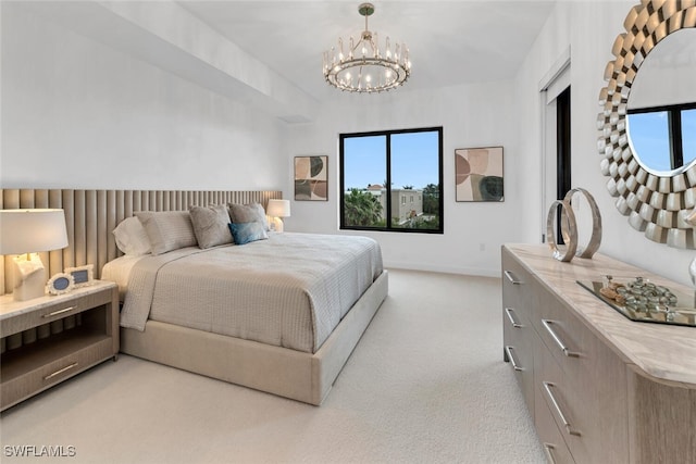 bedroom with a chandelier, light carpet, and baseboards