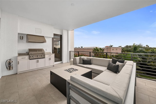 view of patio with area for grilling, grilling area, and an outdoor living space with a fire pit