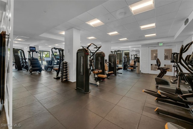 exercise room with a paneled ceiling