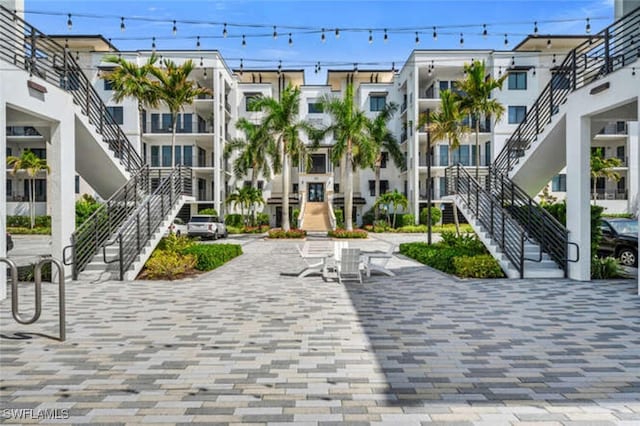 view of community with a patio area and stairs