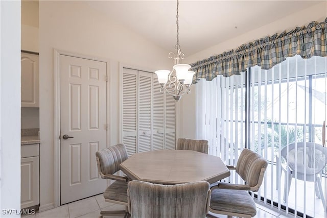 dining room featuring light tile patterned floors, vaulted ceiling, and an inviting chandelier