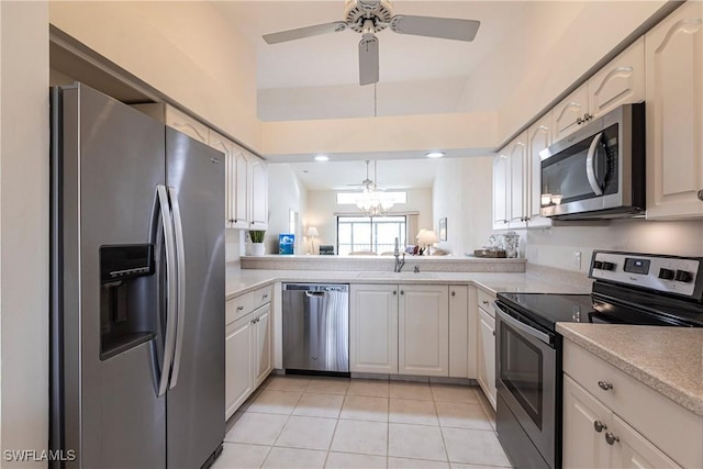 kitchen featuring ceiling fan with notable chandelier, appliances with stainless steel finishes, white cabinetry, sink, and light tile patterned floors