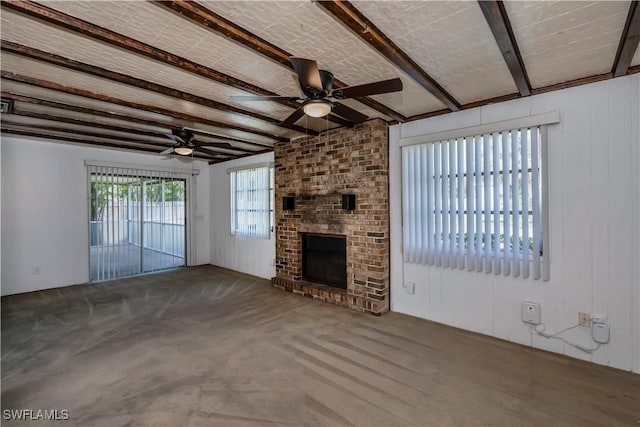 unfurnished living room with beamed ceiling, ceiling fan, brick ceiling, and a brick fireplace