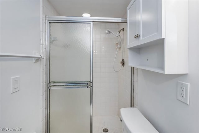 bathroom with toilet and walk in shower