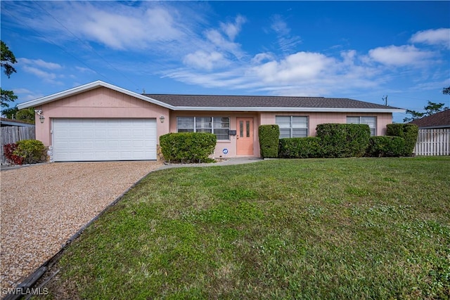 single story home featuring a front yard and a garage