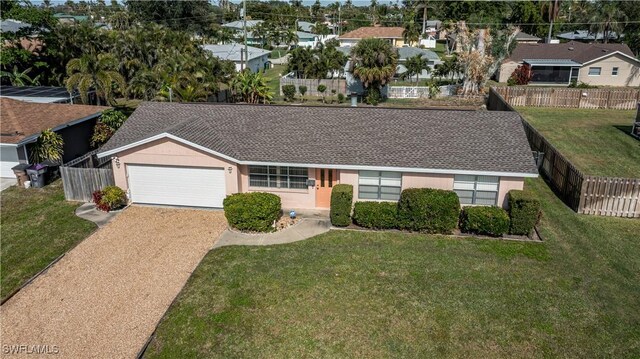 single story home featuring a front lawn and a garage