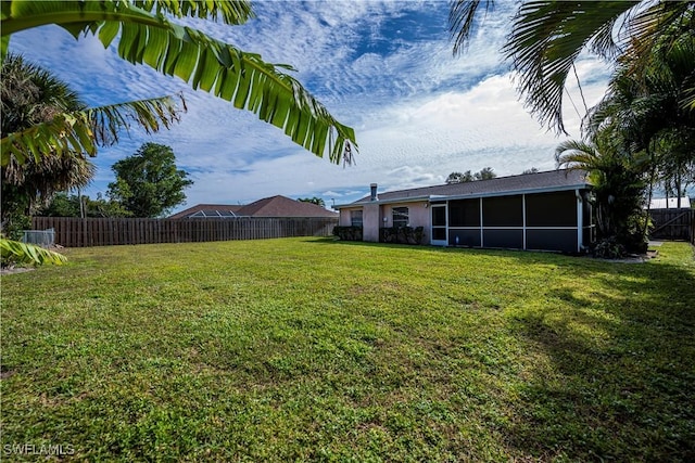 view of yard with a sunroom