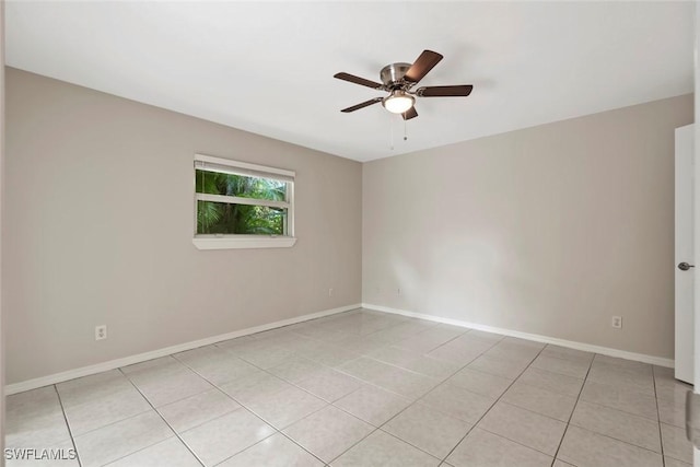 empty room with ceiling fan and light tile patterned floors