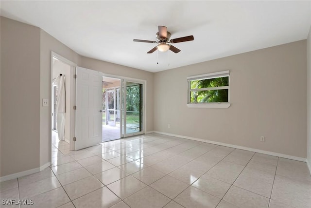 spare room featuring ceiling fan and light tile patterned floors