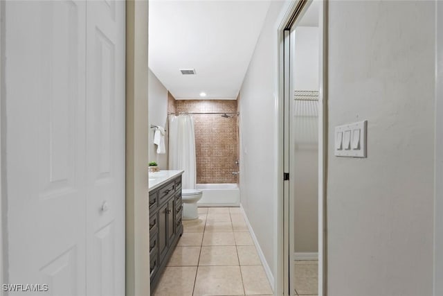 full bathroom with tile patterned floors, vanity, toilet, and shower / bath combination with curtain