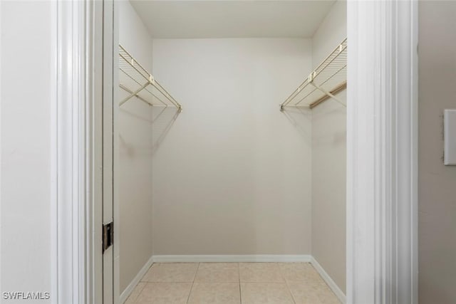 walk in closet featuring light tile patterned floors