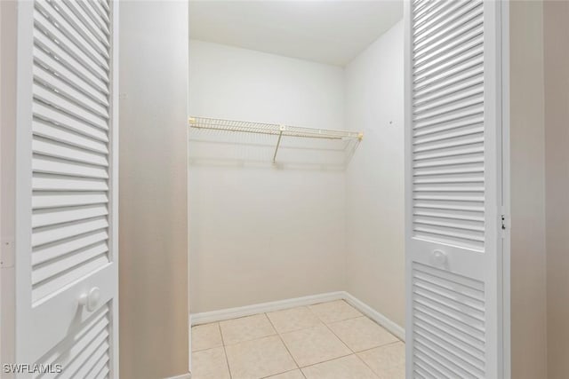 spacious closet with light tile patterned floors