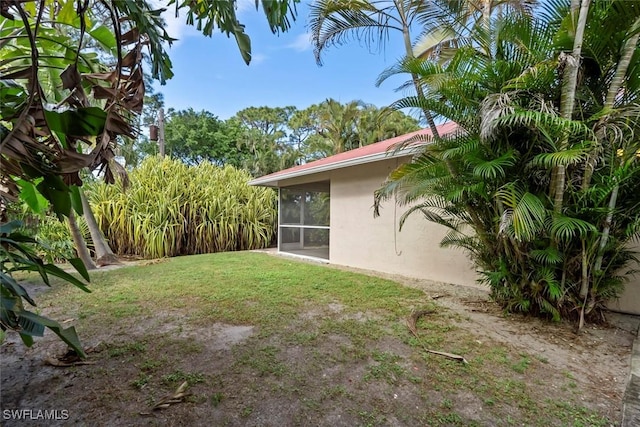 view of yard with a sunroom