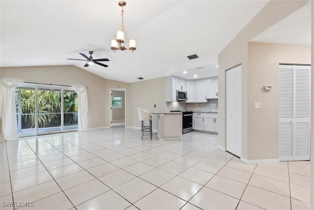 kitchen featuring hanging light fixtures, stainless steel appliances, lofted ceiling, white cabinets, and ceiling fan with notable chandelier