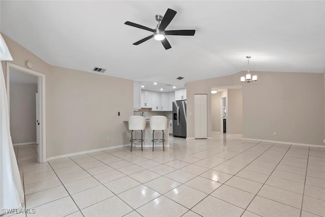 unfurnished living room with light tile patterned floors, ceiling fan with notable chandelier, and lofted ceiling