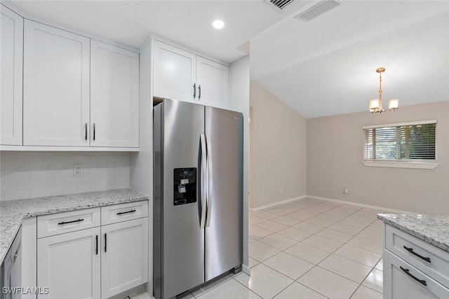 kitchen featuring white cabinetry, stainless steel fridge with ice dispenser, a chandelier, pendant lighting, and decorative backsplash