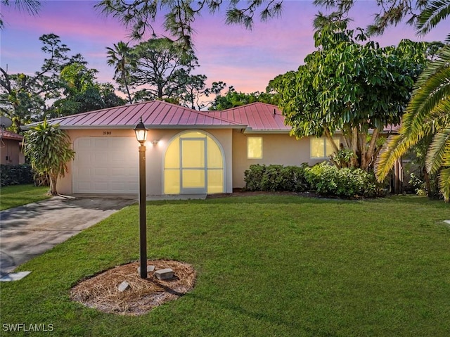 26949 Croise Dr, Bonita Springs, FL 34135 - view of front of property with a garage and a yard
