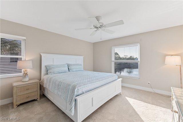 bedroom featuring light carpet and ceiling fan