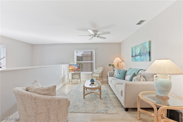 living room featuring ceiling fan and light hardwood / wood-style floors