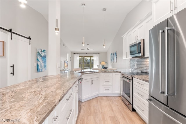 kitchen featuring stainless steel appliances, white cabinetry, hanging light fixtures, and light stone countertops