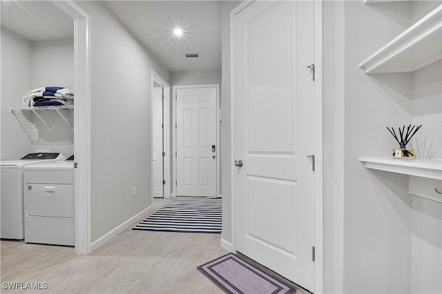 corridor with washer and clothes dryer