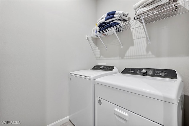 clothes washing area with separate washer and dryer