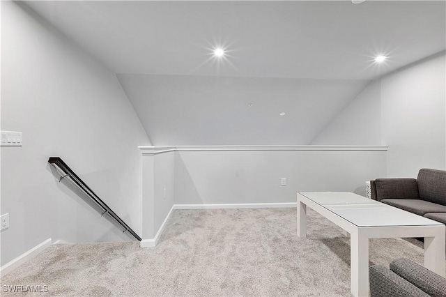 living area featuring vaulted ceiling and light carpet