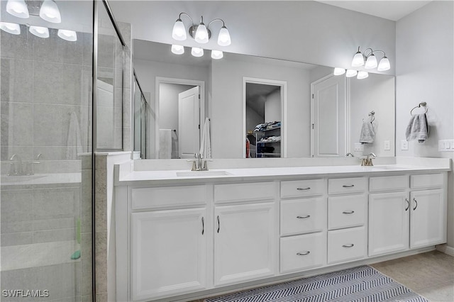 bathroom featuring walk in shower, vanity, and tile patterned flooring