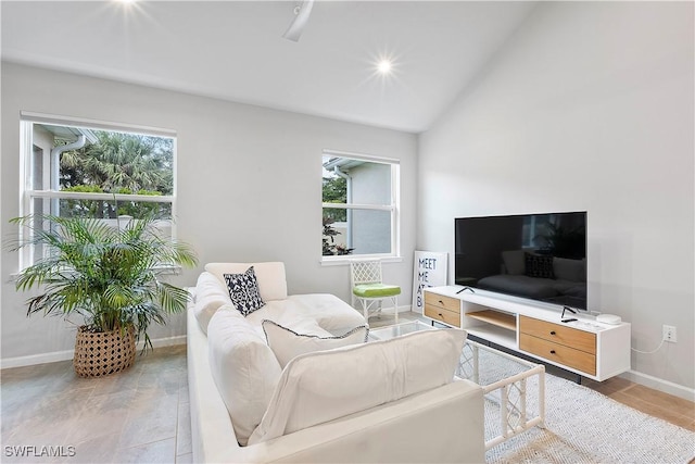 living room with plenty of natural light and vaulted ceiling