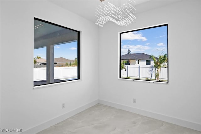 spare room featuring an inviting chandelier