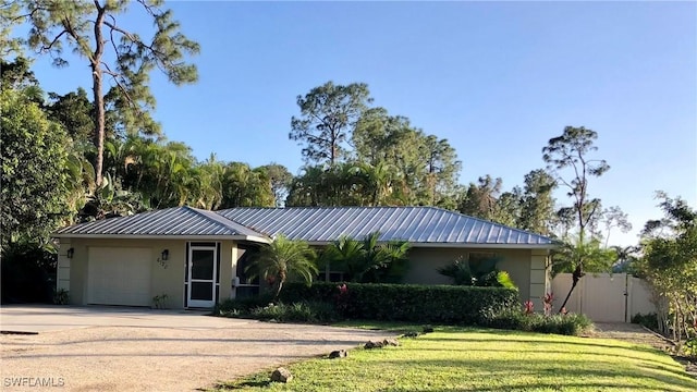 ranch-style home featuring a front yard and a garage