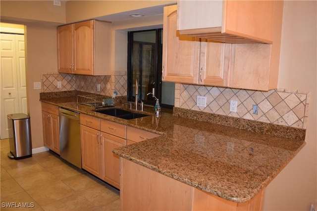 kitchen featuring dishwasher, light brown cabinets, decorative backsplash, stone counters, and sink