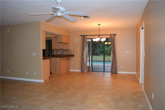 kitchen with ceiling fan with notable chandelier, light brown cabinetry, decorative light fixtures, light tile patterned flooring, and tasteful backsplash