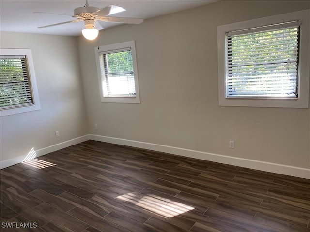 unfurnished room with ceiling fan and dark wood-type flooring