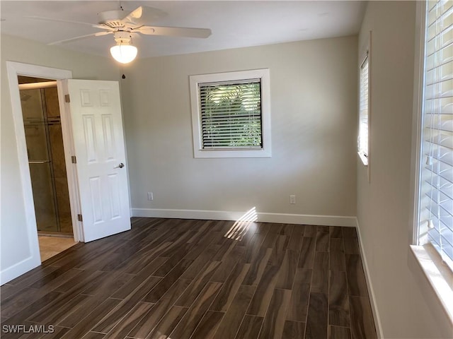 unfurnished bedroom featuring a closet, ceiling fan, and a spacious closet