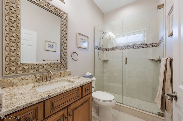 bathroom featuring tile patterned floors, vanity, toilet, and an enclosed shower