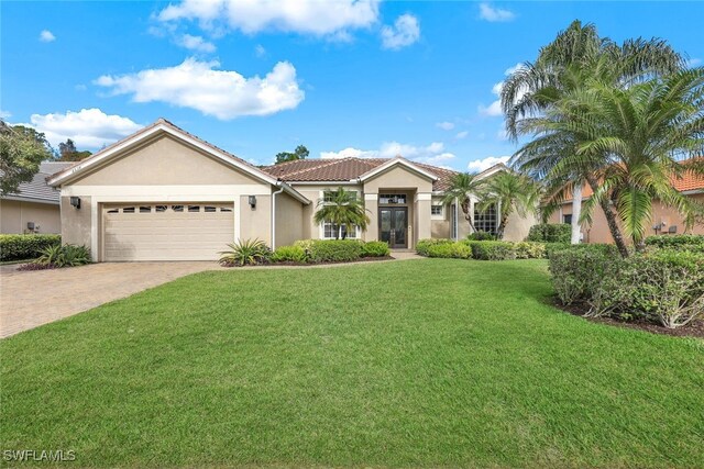 view of front of house with a garage and a front lawn