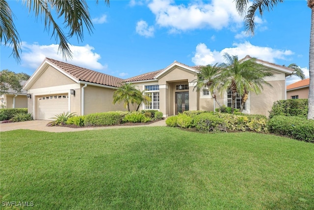 mediterranean / spanish home with a front yard and a garage