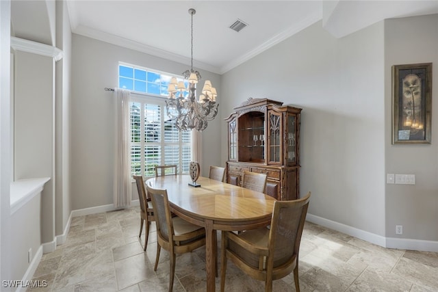 dining room with crown molding and a notable chandelier